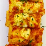 Cheesy Roasted Garlic Bread topped with chopped parsley, made with an easy air fryer recipe