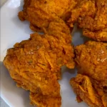 Golden brown Crispy Malaysian Fried Chicken, deep fried in a large pan