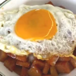 Soy glazed spam rice topped with sunny side up egg, made with a pan and an easy recipe