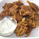 Golden brown Crispy Onion Bhaji or onion fritters, deep fried in a wok or big pan with this easy recipe