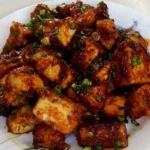 Fried Tofu in dark brown soy and scallion sauce, made in a pan with this easy recipe